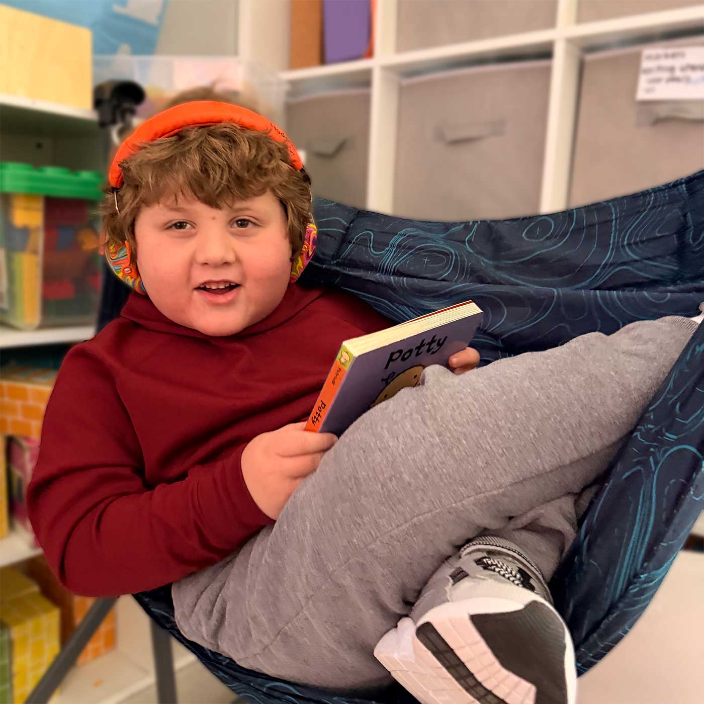 Child with headphones in chair.